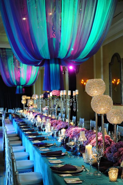 design and decor by Celebrations Ltd, Cayman Islands. | Arabian nights wedding, Arabian nights wedding theme, Wedding decorations Teal Wedding Centerpieces, Purple Teal Wedding, Aladdin Wedding Theme, Arabian Nights Wedding, Teal Wedding Flowers, Purple Turquoise Wedding, Turquoise Wedding Decorations, Aladdin Wedding, Arabian Party