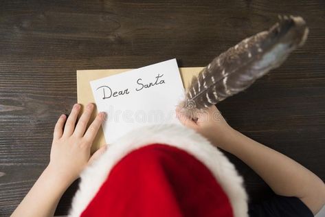 Child writes letter to Santa In santa`s hat. Wooden background. Christmas concept. stock photography Letter For Santa, Old Parchment, Letter To Santa, Background Christmas, Christmas Photoshoot, Christmas Lettering, Santa Letter, Wooden Background, Kids Writing