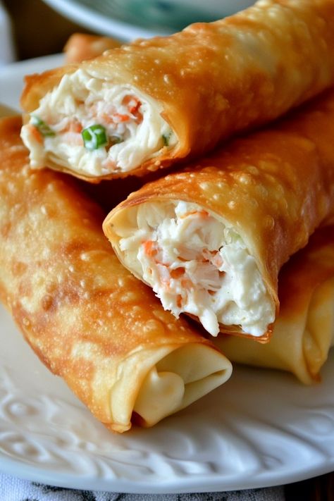 Crab Rangoon Egg Rolls are a delightful treat that will tantalize your tastebuds! Wrapped in crispy wonton skins, these egg rolls are stuffed with a creamy crabmeat filling, offering a creative spin on the classic crab rangoon. These egg rolls are packed with fresh crab meat, cream cheese, and a carefully chosen mix of spices, Crab Rangoon Egg Rolls Recipe, Crab Wonton Recipes, Crabcake Eggrolls, Crab Egg Rolls Recipes, Salmon Egg Rolls, Spring Roll Filling Ideas, Crab Rangoon Egg Rolls, Crab Eggs, Crab Rangoons