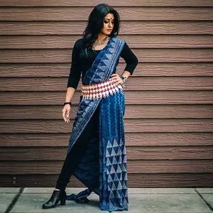 Steal others attention by pairing black boots and pants with a blue saree draped differently Jeans With Saree Outfit, Winter Saree, Indian Boots, Saree Types, Dress From Scratch, Draping Styles, Gudi Padwa, 10 Interesting Facts, Saree Draping Styles