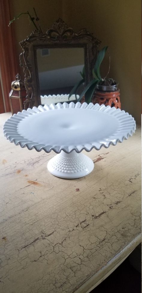 D E S C R I P T I O N:  Vintage Milk Glass Fenton Hobnail Cake Stand; Wedding Cake Stand This beautiful Fenton milk glass cake stand will add a bit of nostalgia to any kitchen or wedding! The ruffed edge and hobnail bottom are timeless! Not all Fenton pieces are marked as they began marking them in 1970. Here is some info regarding Fenton and how to identify authentic pieces. www.rubylane.com/blog/categories/vintage-collectibles/senior-moving-spec... Feel free to message me for additional pictur Milk Glass Wedding, Cake Stand Wedding, Milk Glass Cake Stand, Wedding Cake Stand, Milk Glass Collection, Fenton Hobnail, Fenton Milk Glass, Glass Cake, Glass Cake Stand