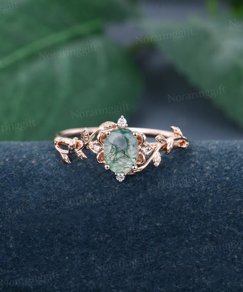 Oval cut Moss Agate engagement ring Unique rose gold Moissanite ring flower ring Dainty Leaf Marriage ring Delicate promise ring Bridal ring -----Ring Information----- +Center stone: 6*8 mm Moss Agate +Cut type: Oval cut +Side Stone:  Natural Diamonds or Moissanite Approx weight: 0.05 ctw Metal : Solid 14k/18k yellow gold white gold or rose gold, other metal or gemstones, please contact me! Click on the "Pin It" icon if you like this item, Thanks so much! Ring Size All rings are standard CA/US s Mossy Engagement Ring, Cottagecore Rings Engagement, Moss Agate Engagement Ring Gold, Engagement Rings Leaves, Cottagecore Engagement Ring, Moss Engagement Ring, Earthy Engagement Rings, Moss Agate Engagement Rings, Montana Sapphire Engagement Ring