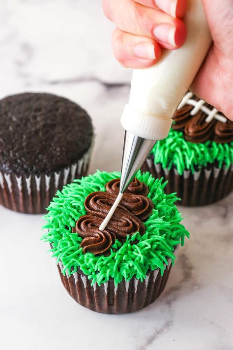 It's officially football season, so it's time to learn how to make these easy football cupcakes! A delicious cupcake is topped with green buttercream grass and a chocolate buttercream football, complete with white laces! Perfect for football watching, parties or a Super Bowl party! Cupcake Cakes For Boys, Panthers Cupcakes, Green Buttercream, Homemade Chocolate Cupcakes, Football Cupcakes, Cookie Ball, Super Bowl Party, Pumpkin Cupcakes, Chocolate Buttercream