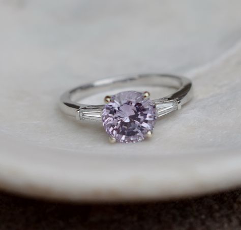 Lilac Sapphire engagement ring.This ring features a 2ct round Lilac sapphire. The stone is very beautiful and clean, tones of sparkles, like a diamond! The color is lilac with lavender and pink overtone.This beauty is set in a 14k white gold diamond setting, 2 baguette diamonds on the sides, TDW 0. Lavender Diamond Ring, Lilac Sapphire Engagement Ring, Lilac Wedding Ring, Lilac Engagement Ring, Lilac Ring, Lilac Sapphire, Round Sapphire Engagement Ring, Gold Diamond Ring Engagement, Engagement Ring Baguette