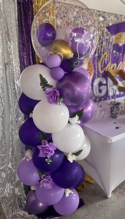 Balloon column, flowers, graduation Graduation Purple Theme, Balloon Columns With Flowers, Purple Balloon Columns, Butterfly Balloon Column, Purple And White Graduation Party Ideas, Purple Graduation Party Ideas, Purple And Gold Party Decorations, Balloon Centerpieces Diy, Balloons Centerpieces