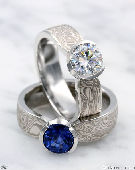 This matching mokume engagement ring set was handcrafted in platinum and our White Mokume Gane with a round diamond and round sapphire! Lesbian Engagement Ring, Gay Wedding Rings, Lesbian Wedding Rings, Hers And Hers, Solitaire Engagement Ring Set, Lesbian Engagement, Moissanite Engagement Ring White Gold, Gold Knot Ring, Solitaire Engagement Ring Settings