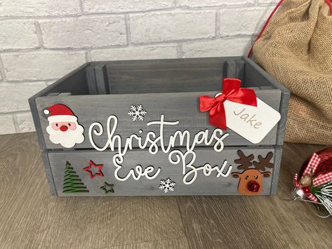 These personalised grey wooden crates with hand painted embellishments are perfect for those Christmas Eve treats such as PJ's, slippers, hot chocolate etc. These personalised boxes will really add to the excitement of the evening and sure to be treasured for years and years. Made from grey washed pine and measuring 23 x 31 x 15cm these sturdy boxes can be reused many times over. All of our products are handmade to order using the highest quality materials. These are individual wooden crates so some knots and blemishes are unavoidable. Some basic assembly required on receipt, (tools required Phillips crosshead screwdriver). Posted flat for ease of shipping and to avoid damages. Diy Christmas Eve Box, Grey Christmas Decor, Wooden Crates Christmas, Christmas Eve Crate, Wooden Christmas Eve Box, Xmas Eve Boxes, Personalised Christmas Eve Box, Christmas Eve Gift, Wood Gift Box