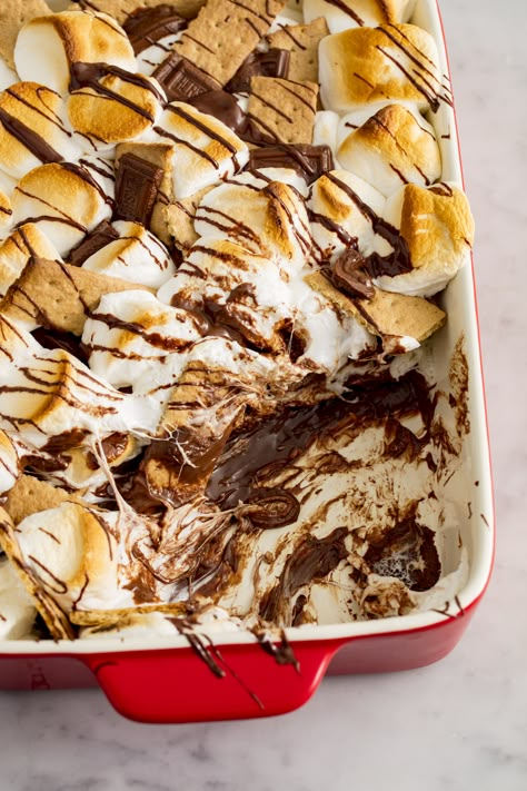 S'mores Bake = Easiest Dessert You'll Ever MakeDelish S’more Desert Ideas, Baked Smores Dessert, S’mores Cobbler, Smore Casserole Recipes, S’more Desert, Quick And Easy Smores Desserts, Smore Nachos Oven, Easy S’mores Dessert, Smores Dessert Grill