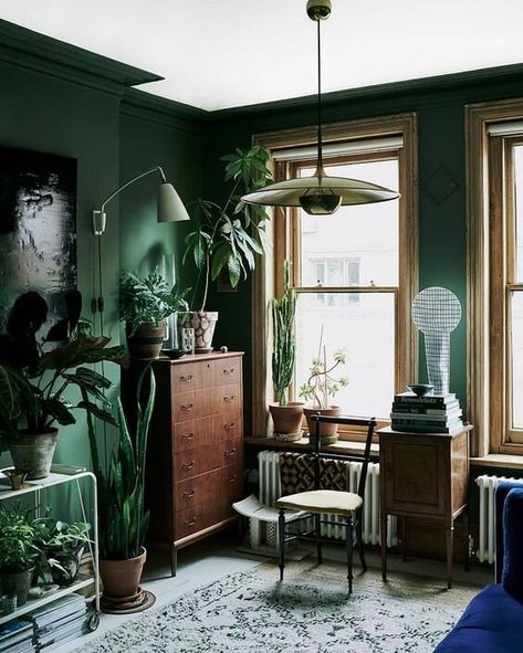 I’m in deep for dark green spaces. Whether it’s a teal or kelly green accent wall, an emerald green bedroom or an olive living room jungalow - green lends itself well to rustic, boho, + modern styles and gives everything a lush verdant jungle vibe. It makes metallic gold + brass pieces pop. Whatever color scheme you like best, there’s no wrong way to decorate with shades of green. Click for some of our favorite decor ideas and rooms that inspire. Dark Green Living Room, Lots Of Plants, Interior Design Minimalist, Elle Decoration, Gold Aesthetic, Bohol, Living Room Green, Green Interiors, Green Rooms