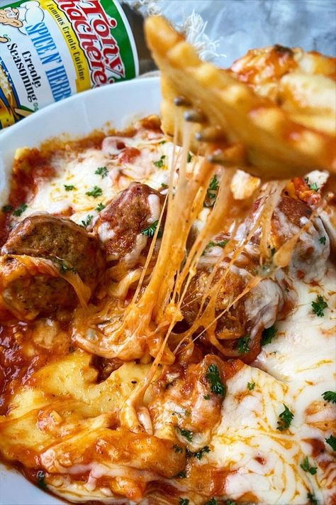 This Cheesy Ravioli is packed with flavor. Here, it's shown alongside a can of Tony Chachere's with a tasty bite being prepared. Ravioli And Meatballs, Cajun Meals, Cheesy Ravioli, Ravioli Casserole, Meatball Casserole, Mardi Gras King Cake, Frozen Meatballs, Herb Seasoning, Lunch Dinner Recipes