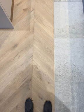 Wooden Floors Project in UK and Worldwide. Parquet With Tiles, Grey Tile And Wood Floor Transition, Concrete And Wood Flooring, Tile Meets Wood Floor, Grey Parquet Flooring, Silver Flooring, Chevron Tiles Floor, Tile To Wood Transition, Chevron Parquet