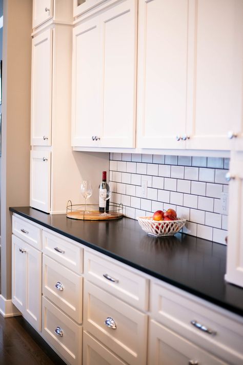 Subway tile kitchen with white cabinets and black granite countertops! Traditional home design with distressed wood decals and wall decor! White Subway Tile Black Countertops, Kitchen Design With Black Granite Top, White Cabinets Black Granite Backsplash, Wood Decals, White Cabinets Black Countertops, Kitchen With White Cabinets, Black Kitchen Countertops, Kitchen Cabinet Trends, Outdoor Kitchen Countertops