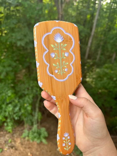 Beautiful hand painted hair brush! Bamboo brush delicately hand painted with a light purple and green floral design. Message me to discuss different color options! Painted Hairbrush, Hand Painted Hair, Painted Mirror Art, Painted Bamboo, Green Floral Design, Bamboo Brush, Fairy Home, Wooden Brush, Painting Brush