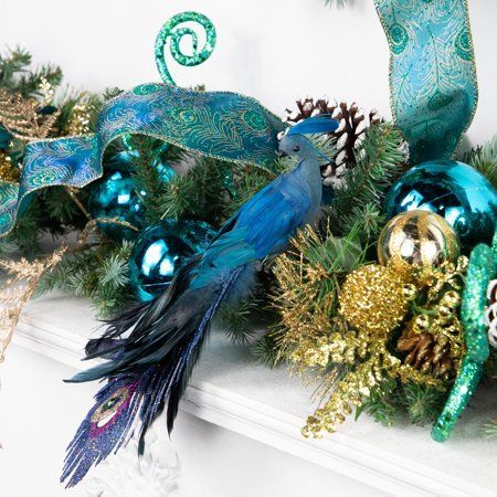 This regal peacock presents itself with elegance and grace. Embellished with faux green jewel and glitter, it adds the perfect amount of sparkle. Ideal for your Christmas tree, wreaths, garlands, floral arrangements, or centerpieces. . Product Features: Clip on peacock Christmas ornament. Purple, blue and gold tail is embellished with glitter. Faux green jewel accents tail. Fully dimensional ornament. Comes ready-to-attach with a crocodile clip. Recommended for indoor use only. Dimensions: 3"H x Christmas Tree Wreaths, Tree Wreaths, Peacock Ornaments, Peacock Christmas, Blue Peacock, Peacock Bird, Christmas Tree Wreath, Wreaths & Garlands, Holiday Tree