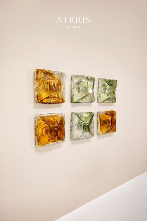 It's almost like having an exquisite set of jewels hanging on the wall. That is what this set of six wall lamps radiate. They are made from Murano glass and therefore have a distinctive appearance that is so characteristic of Italian hand-blown glassware. With the light sources off, this set is a pleasure to look at. green lamp | amber colored glass | Murano glass | wall sconces | wall lamps | vintage lighting | Italian design | 1970s design Murano Wall Light, Lamp Making, 1970s Design, Green Lamp, Lamps Vintage, Curved Lines, Furniture Upholstery, Amber Color, Apple Green