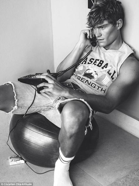 Athletic: The sporty theme continues with Oliver Cheshire in a black and white image sitting in a baseball jersey and ripped shorts as he chats on the phone, leaning against a wall Oliver Cheshire, Attitude Magazine, Fashion Art Photography, Oita, Ripped Shorts, Male Fashion Trends, Sleeveless Tshirt, Beach Bum, Male Beauty