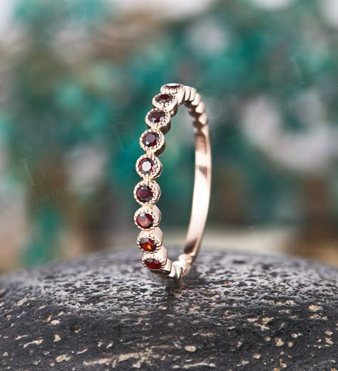 Garnet wedding band women Unique 14k rose gold half eternity Antique Stacking ring Vintage Bridal Jewelry Anniversary Promise Gift for her  --------------------Specifications---------------------- Stones - approx 0.35-0.4ct Garnet ---------------------DIMENSIONS---------------------- The Width of the Band - 1.5 mm The Thickness of the Band - 1.3 mm Weight of gold - about 1.5 g Ring Head - about 2.0 mm Height ---------------------------SIZES----------------------------- This ring is made to order in any size, Please drop down the Options box to choose the gold color and ring size. size 9 and above will be priced individually. ---------SHIPPING AND MAKING TIME--------- The ring will be made within 2-3 weeks from the time of payment. Default shipping method(USPS) takes 3-5 business days to an Garnet Wedding Band, Topaz Wedding Ring, Garnet Wedding, Elegant Wedding Rings, January Birthstone Rings, Bridal Jewelry Vintage, Wedding Ring Box, 14k Rose Gold Ring, Half Eternity Band