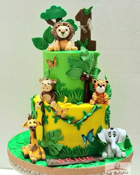 Jungle theme Cake Two Tier Safari Theme Cake, Cake Designs Jungle Theme, Jungle Theme 1st Birthday Party Cake, Safari Cake Design Jungle Animals, 2 Tier Safari Birthday Cake, Forest Theme Cake For Kids, Animal Theme Cake Without Fondant, Birthday Cake Jungle Theme, Jungle Theme Cake Without Fondant