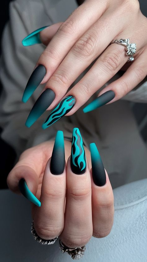 Turn heads with this daring flame-inspired nail design! Featuring a striking gradient of deep black and vibrant turquoise, these long stiletto nails are a perfect blend of edgy and elegant. The matte finish adds a modern touch, while the bold flame detailing is sure to make a statement at any event. Black And Turquoise Nails, Black And Blue Nail Designs, Nail Art Flames, Black And Blue Nails, Long Stiletto Nails, Turquoise Nails, Long Stiletto, Blue Nail Designs, Deep Black