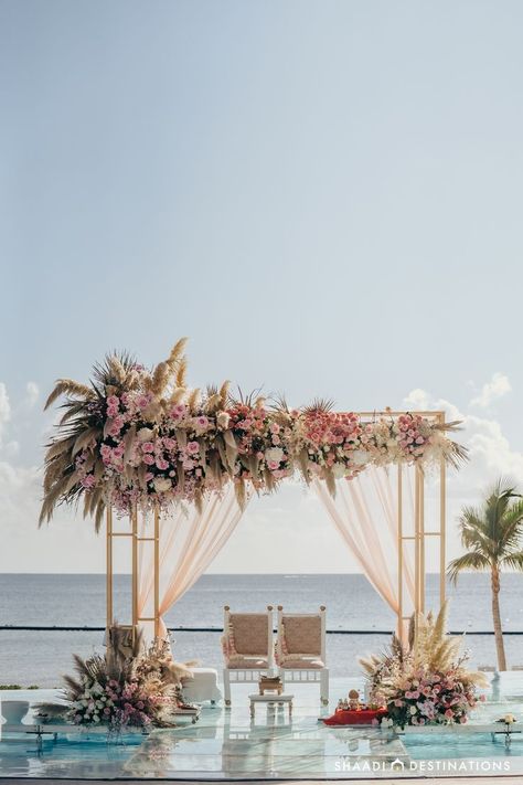 Indian destination wedding ceremony set over the resort pool at Dreams Natura with a clear aisle and the most beautiful mandap. And to take it a step further? The ocean serves as a backdrop behind the happy couple Beach Side Indian Wedding, Boho Wedding Gazebo, Beach Mandap Decor, Garden Beach Wedding, Pastel Mandap, Mauritian Wedding, Rustic Mandap, Mandap Outdoor, Beach Wedding Backdrop