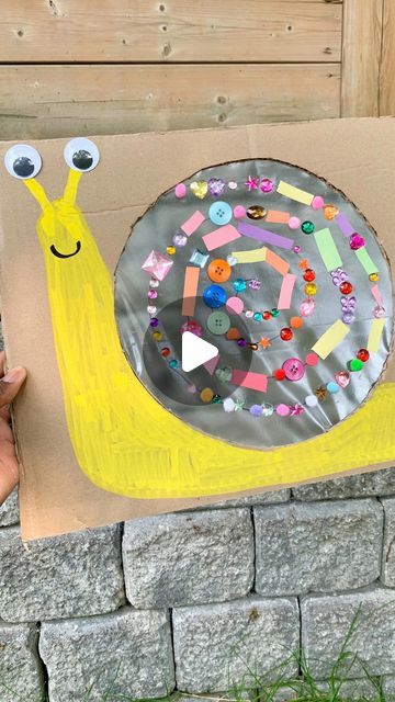 Mandisa | Easy Activities for Toddlers & Kids on Instagram: "🐌🌈 Sticky Board Snail Craft! 🌈🐌

Looking for a fantastic and engaging craft activity for your little ones? Check out our sticky board snail craft made with cardboard and contact paper! 🎨📦

🎉 This colorful and adorable snail creation is not only fun to make but also perfect for developing fine motor skills in kids. 🤗 They’ll love choosing their favorite colors and sticking them onto the contact paper, creating a one-of-a-kind snail masterpiece!

🌟 Materials needed:
- Cardboard 📦
- Contact paper 🍃
- Assorted colored paper 🎨
- mini Pom Poms, gem stones, foam shapes, pony bead
- Scissors ✂️
- Googly eyes 👀
- Glue 🎀
- Markers

🌈 Step-by-step:
1️⃣ Cut out a large circle in the middle of the cardboard, cover it with conta Snail Craft, Mini Pom, Foam Shapes, Kindergarten Crafts, Craft Activity, Easy Activities, Googly Eyes, Contact Paper, Sensory Activities