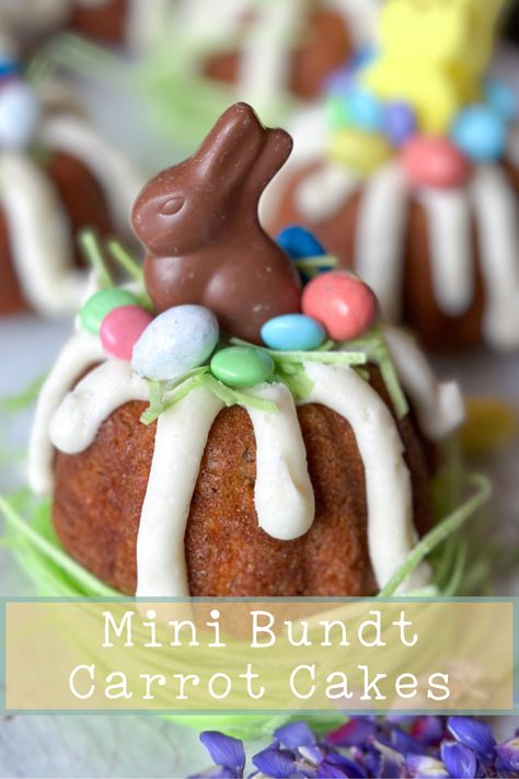 One mine bundt carrot cake sitting on edible grass topped with decorations Mini Bundt Carrot Cakes, Carrot Cake Bundt Cakes, Individual Carrot Cake Desserts, Easter Mini Bundt Cakes, Individual Easter Desserts, Individual Carrot Cake, Mini Easter Desserts, Mini Bundt Cake Recipes, Carrot Cake Bundt