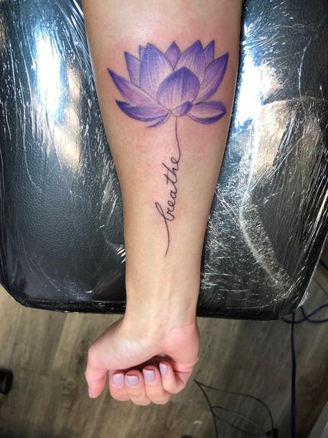 Purple lotus flower tattoo, breathe word tattoo Breath Lotus Tattoo, Purple Water Lily Tattoo, Colour Lotus Flower Tattoo, Lotus Flower Tattoo Purple, Lotus Flower And Breathe Symbol Tattoo, Purple Lotus Tattoo, Lotus Tattoo Meaning, Blue Lotus Tattoo, Purple Flower Tattoos