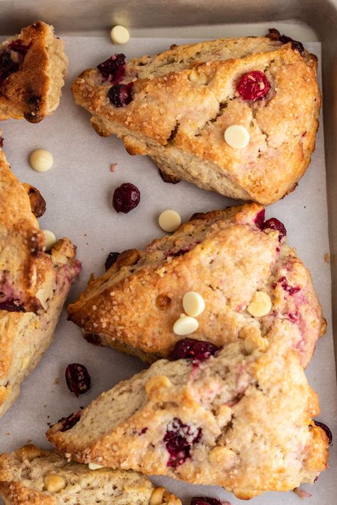 A batch of golden scones with cranberries and white chocolate baked inside. Cranberry White Chocolate Scones, Dessert Scones, Cafe Specials, Cranberry Almond Biscotti, Cranberry Treats, White Chocolate Scones, Easy Delicious Breakfast, Pop Overs, Apple Cider Glaze