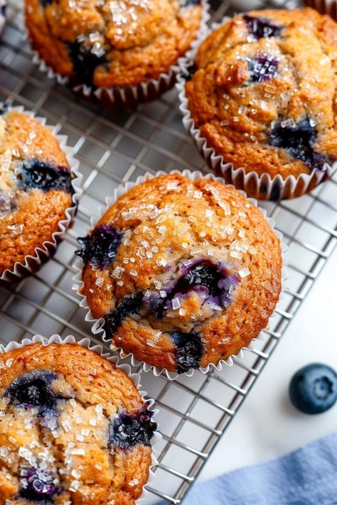 Perfectly moist with bursts of sweet blueberries in every bite, these banana blueberry muffins are a delightful treat for breakfast or a midday snack. Apple And Blueberry Muffins, Justine Snacks Blueberry Muffins, Healthy Yummy Muffins, Moist Banana Blueberry Muffins, Healthy Moist Banana Muffins, Blueberry Muffins No Milk, Blue Berries Muffins, Blueberry Banana Oat Muffins, Muffins With Bananas