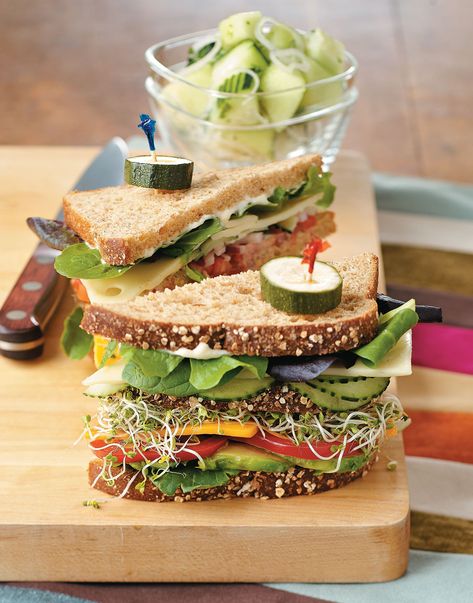 If you don't think a veggie sandwich can be hearty and filling, think again. This recipe for Vegetarian Dagwood Sandwiches piles vegetables, cheese, and avocado onto slices of multi-grain bread, making for a super-tall, quick, and healthy lunch or dinner you'll want to sink your teeth into. Peach Moscow Mule, Dagwood Sandwich, Vegetable Sandwich Recipes, Easy Stuffed Cabbage, Multi Grain Bread, Kitchen Notes, Cold Sandwiches, Layered Salad, Vegetarian Sandwich