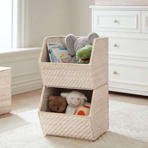 Kids can easily declutter their room by stowing toys, books and games in these stylish stacking bins. The angled, open design makes it easy to take their belongings out-and put them back in. Woven around a sturdy metal frame, the whitewashed rattan complements any decor. Slight variations in color and finish are hallmarks of time-honored weaving techniques. DETAILS THAT MATTER Handmade of hapao woven rattan over a metal frame. Edge weave features a buri binding. Features a Whitewashed finish. Bi Changing Table Storage, Stacking Bins, Toy Storage Solutions, Stackable Bins, Storage Kids Room, Kid Toy Storage, Nursery Storage, Bookshelves Kids, Crib Mobile