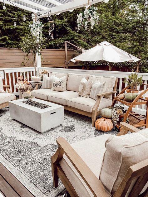 Create a cozy fall deck or patio in your backyard outdoor living space with cozy cottage style neutral beige sand color linen and wood outdoor furniture, a charcoal grey vintage floral farmhouse outdoor area rug from Boutique Rugs, a propane fire pit / concrete gas firepit, fairytale pumpkins and rustic earthy faux fall floral stems. - Rain and Pine #fallfarmhousedecor #falldecor #outdoorliving #backyard #patiodecor #cottagedecor #farmhousedecor #cozydecor #neutraldecor #fallpatiodecor Fairytale Pumpkins, Fall Patio Decor, Fall Deck, Fall Patio, Boutique Rugs, Floral Farmhouse, Outdoor Fire Pit Table, Rectangular Fire Pit, Farmhouse Outdoor