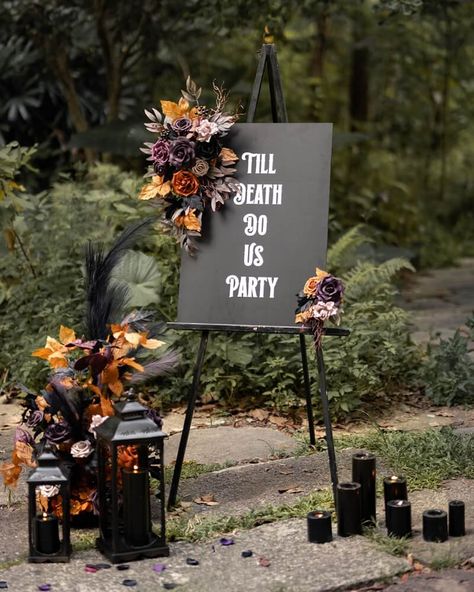 If you’re anything like us, you believe that Halloween vibes shouldn’t be confined to October 31st. You deserve to celebrate tricks, treats, and all things pumpkin spice whenever you feel like it. That includes your wedding day! We created our 2023 Halloween wedding collection for hopeless dark romantics like you. Shad Black And Plum Wedding Cake, Outdoor Halloween Wedding Decorations, Red Black And White Rustic Wedding, Modern Goth Wedding Decor, Black And Mulberry Wedding, Small Black Wedding Ideas, Dark Wedding Signs, Black And Wood Wedding Decor, Black Purple Orange Halloween Wedding