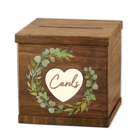 "Buy Kate Aspen Rustic Brown Wood Card Box at Michaels. com. Receiving gifts and cards is one of the sweetest ways guests show their support for your new marriage. Rustic Brown Wood Card Box by Kate Aspen is functional, cute décor for your next wedding or party. The wedding card box has a faux wood print allowing it to fit in with all the décor you already have put together. Green leaves make up the wreath that is found in the middle of the top of the box. In the center of the wreath is a pink t Wood Card Box, Bridal Gift Box, Beautiful Wooden Boxes, Wedding Card Box, Wood Card, Moving Gifts, Cursive Font, Card Box Wedding, Gift Table