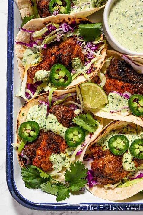 These pork belly tacos are the best of all worlds! Warm tortillas are stuffed with seasoned pork belly, crunchy cabbage, cilantro, and a drizzle of our easy homemade taco sauce. They come together easily and they're ready in an hour! #theendlessmeal #tacos #porkbellytacos #porkbelly #porktacos #pork #dinner #mexican #texmex Blackened Fish Tacos, Blackened Fish, Blacken Fish, Avocado Dessert, Cilantro Sauce, Dash Diet, God Mat, Think Food, Fish Tacos