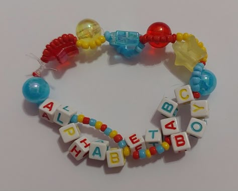 My alphabet boy inspired bracelet for the trilogy tour ! (Not for trade)          Tags: #melaniemartinez #trilogytour #bracelets #handmade #portals #k12 #crybaby #extraclutterep #afterschoolep #aftershcool #extraclutter #dollhouseep #dollhouse #concert #melanie #mel #fairy #faerie #lyrics #songs #music #fairycore #necklace #ocean #sea #necklace #seaturtle #turtle #pink #blue #starfish #dolphin #necklacr Melanie Bracelet Ideas, Melanie Martinez Braclets Ideas, Portals Bracelet, Trilogy Tour Bracelets, Melanie Martinez Themed Bracelets, Melanie Martinez Bracelet Idea, Melanie Martinez Bracelet Idea K-12, Melanie Martinez Trilogy Tour Bracelets, Boys Bracelets