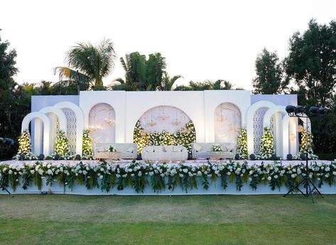 Gold and White blooms, This combination creates a dreamy and enchanting atmosphere for the timeless union. 🌸✨ Event planner : @knoti5 Production& structure : @eventi_5 & @rentaffair Location : @vedik_resort #EventDecor#pastelwedding #ElegancePersonified” #wowE5#walkway #themedecor #trendingdecor#weddingdecoration#weddinginspiration#weddingideas #eventproduction #eventlife #weddingdecor #eventdesigner #eventstylist #eventstyling #weddingplanning#eventideas#RentAffair#weddingprops#Rentalpr... White Stage Decoration Wedding, Gold White Wedding Decor, Ivory Stage Decor, Stage Decorations White Background, White Background Stage Decoration, Wedding Stage White Theme, Reception Stage Decoration Backdrops, Diy Backdrop Stand, Floral Bedroom Decor