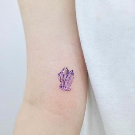 Now, this little Amethyst tattoo we can get behind! 💜💎 It's tiny and perfect and bound to give you all the good juju throughout the day! 🤩… Amethyst Tattoo, Small Watercolor Tattoo, Tattoo White, Crystal Tattoo, Palm Tattoos, Stylish Tattoo, Sweet Tattoos, Small Girl Tattoos, Black Amethyst