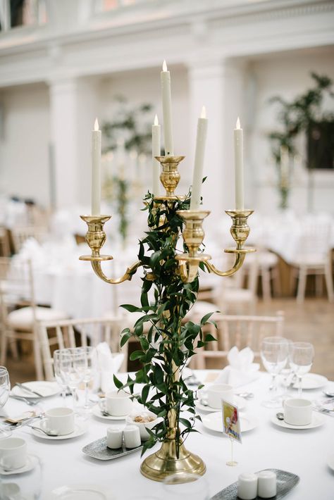 Gold Candelabra dressed with ivy foilage or ruscus! Tall Gold Candelabra Wedding Table, Gold Candleabra Centrepiece, Candle Abra Decor, Gold Candleabra Wedding, Baroque Wedding Decor, Gold Candelabra Centerpiece Wedding, Candleabras Wedding, Candelabra Centerpiece Flowers, Gold Candelabra Centerpiece