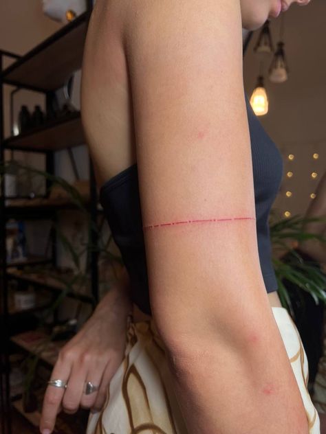 #tattoo #tattooideas #tattoodesign #aesthetic #tattoofineline Red Line Wrist Tattoo, Red Arm Band Tattoo For Women, Fineline Red Tattoo, Red Tattoo Fine Line, Healed Red Tattoo, Red String Theory Tattoo, Bicep Wrap Tattoo, Small Red Tattoos For Women, Take Care Tattoo