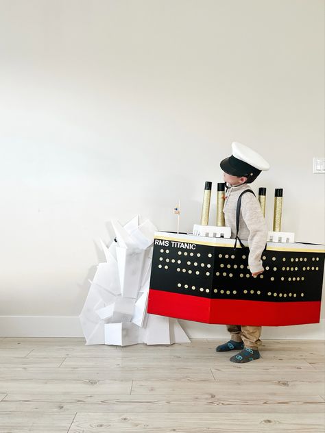 My son asked to be the titanic for halloween. I bought sheets of corregated plastic board and some cardstock from michaels. I used duct tape for the colours from dollarama. The frame is built arlind a diaper box. Titanic Costume, Plastic Board, The Titanic, Duct Tape, Titanic, My Son, The Frame, Card Stock, Halloween