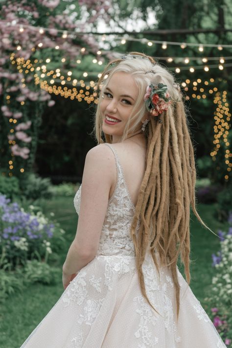 Discover the stunning beauty of this elegant dreadlock updo, a perfect choice for modern brides seeking unique wedding hairstyles. This mesmerizing style features intricately twisted dreadlocks artfully arranged to create a chic and sophisticated look. Accentuated with delicate floral accessories, this bridal hairstyle beautifully blends cultural richness and personal flair, ensuring you stand out on your special day. #weddinghairstyles Twisted Dreadlocks, Dreadlock Updo, Unique Wedding Hairstyles, Bridal Hairstyle, Dread Hairstyles, Dreadlock Hairstyles, Floral Accessories, Unique Wedding, Bridal Hair