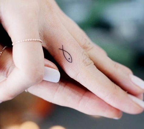 68 Unique Small Finger Tattoos With Meaning - Our Mindful Life Finger Fish Tattoo, Minimalistic Fish Tattoo, Christian Fish Tattoo For Women, Fish Finger Tattoo, Mini Tattoo Ideas With Meaning, Christian Finger Tattoos, Unique Small Tattoo With Meaning, Finger Tattoos Meaningful, Inner Finger Tattoos For Women