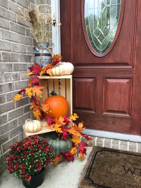 Cute front porch fall decor! Pumpkins, mums, and more. Create a really pretty focal point for the fall season. Fall Mum Front Porch Decor, Wood Crates Fall Decor, Fall Crate Porch Decor, Mums Front Porch Fall Displays, Autumn Front Porch Decor, Thanksgiving Decor Ideas, Small Porch Decorating, Fall Yard Decor, Fall Front Porch Decor Ideas