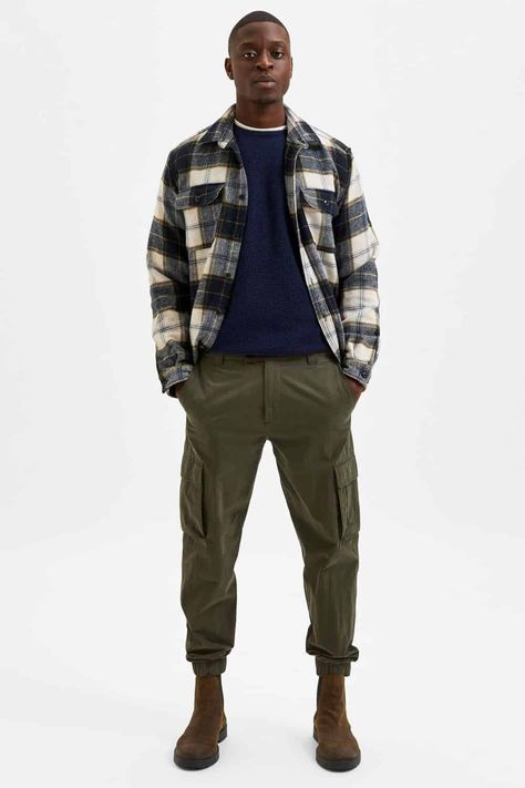 Men's green cargo pants, flannel over shirt and chelsea boots outfit. This outfit first appeared in the article: Men’s Green Pants Outfit Inspiration: 14 Modern Looks For 2022, on MensFlair.com Military Boots Outfit, Chelsea Boot Outfit, Green Pants Men, Green Pants Outfit, Chelsea Boots Men Outfit, Dark Green Pants, Chelsea Boots Outfit, Boots Men Outfit, Boots Outfit Men