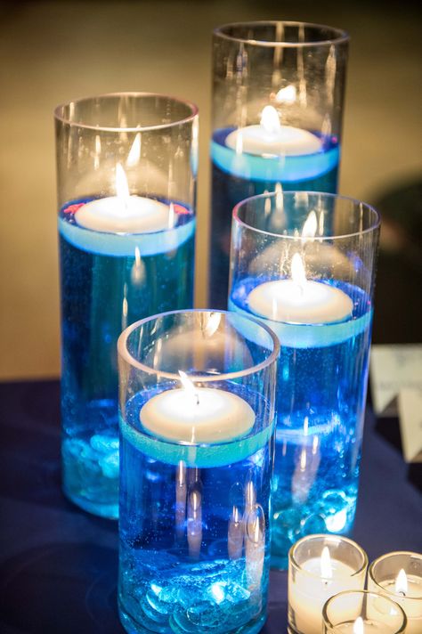 floating candles, blue dyed water, tea lights Blue Floating Candles, Futuristic Wedding, Water Centerpieces, Tea Lights Centerpieces, Tea Lights Wedding, Floating Candle Centerpieces Wedding, Diamond Birthday, Floating Candles Wedding, Prayer Breakfast