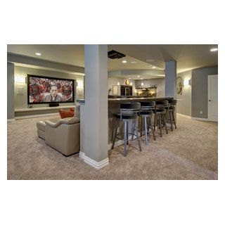 Basement TV wall with drink ledge and bar stools. ©Finished Basement Company Home Theater Basement, Transitional Basement, Basement Home Theater, Basement Bar Designs, Man Cave Basement, Basement Living Rooms, Basement Makeover, Basement Design Ideas, Home Theater Design