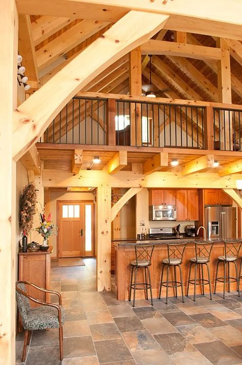 Handcrafted posts support custom timber trusses with loft above kitchen and entryway. Loft Above Kitchen, Timber Frame Cabin, Cabin Loft, Barn Loft, Wooden House Design, Open Loft, Timber Frame Home, Exterior Finishes, Barn House Design