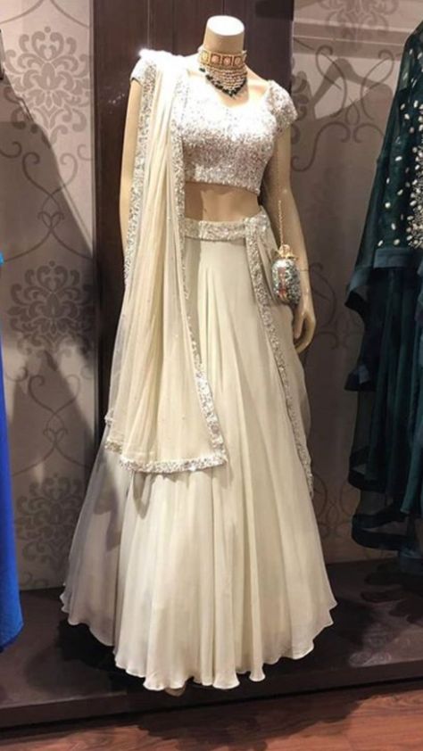 Beautiful cream-white Georgette-Silk Lehenga with Hand Embroidered blouse.  Embellished with dupatta.  The color of this Lehenga is so classic and sober. Milk silver hand embroidery give much glitter and shine. #Lehenga #traditional #festival #handembroidery #asmaira #design Cream Colour Lehenga, Georgette Lehenga Designs, Off White Lehenga Combination, White Georgette Lehenga, Cream Lehenga, Lehenga Traditional, Lehenga White, Glitter Gown, Hand Embroidered Blouse