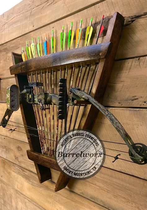 "the bourbon barrel archery rack features two locations to hanger you bow, and room for 12 arrows. Bourbon barrel staves make up the front and sides of this shelf display, the unique shape and style of the barrel staves gives this rack a one of a kind look that will give your den or hunting/trophy room a look like no one else. bow and arrows not included. Dimensions Overall width at top 28\" Overall height 30\" Depth from wall 3.5\" Due to the nature of building with barrel staves sizes are appr Hunting Storage Room, Diy Bow Rack, Bow And Arrow Decor, Hunting Storage Ideas, Wood Bow Holder, Diy Bow Holder Archery, Archery Rack Diy Bow Holders, Archery Bow Holder, Hunting Trophy Room